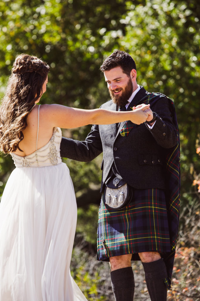 groom looking at bride in wedding dress | John Patrick Images | As seen on TodaysBride.com