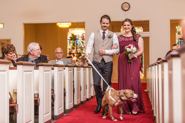 Bridesmaid and Groomsman walking Dog down the Aisle | The Cleveland Photographic Co. | As seen on TodaysBride.com