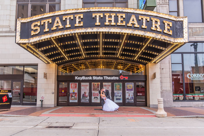 Bride and Groom Kissing in front of Theater | The Cleveland Photographic Co. | As seen on TodaysBride.com