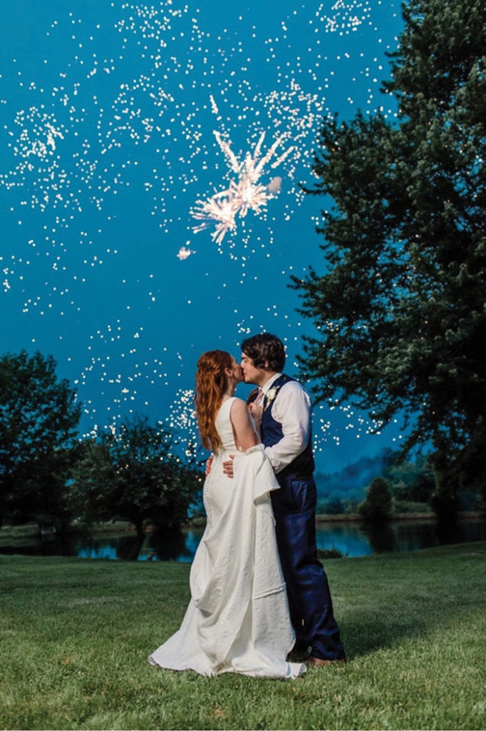 Bride and Groom Kissing with Fireworks | River Top Coordinating | As seen on TodaysBride.com