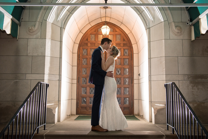 Bride and Groom kissing in front of church doors | Sabrina Hall Photography | As seen on TodaysBride.com