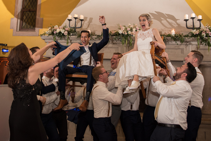 Bride and Groom being hoisted on chairs | Sabrina Hall Photography | as seen on Todaysbride.com