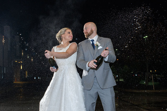 Bride and Groom spraying champagne | Cirino Photography | As seen on TodaysBride.com