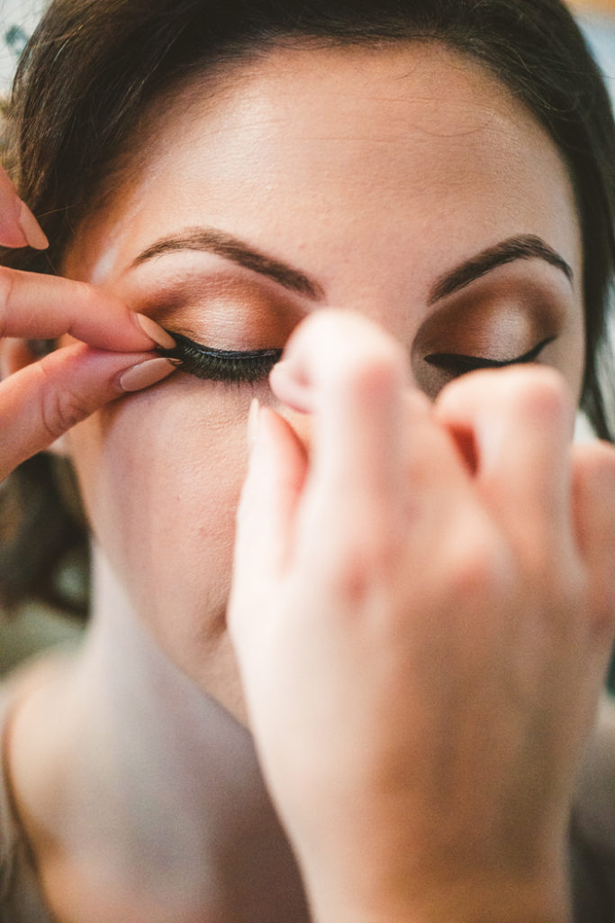 Woman applying fake eye lashes | too much awesomeness | As seen on TodaysBride.com
