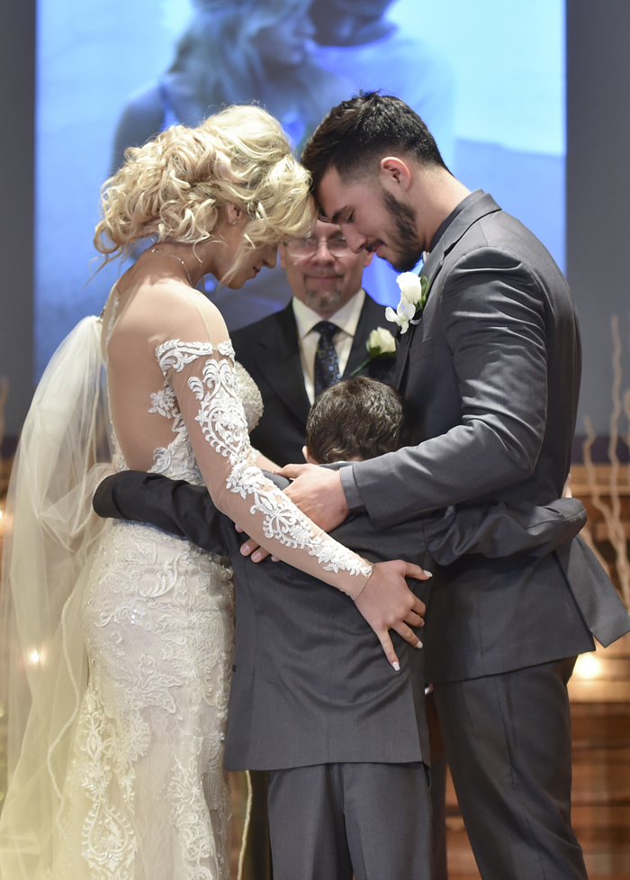 Bride, Groom, and Child hugging | Rising Star Photography | As seen on TodaysBride.com