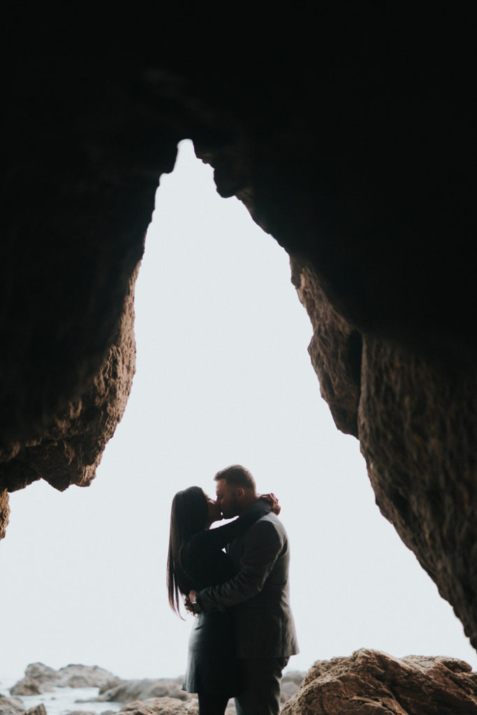 Couple on Honeymoon Kissing in a Cave | As seen on TodaysBride.com