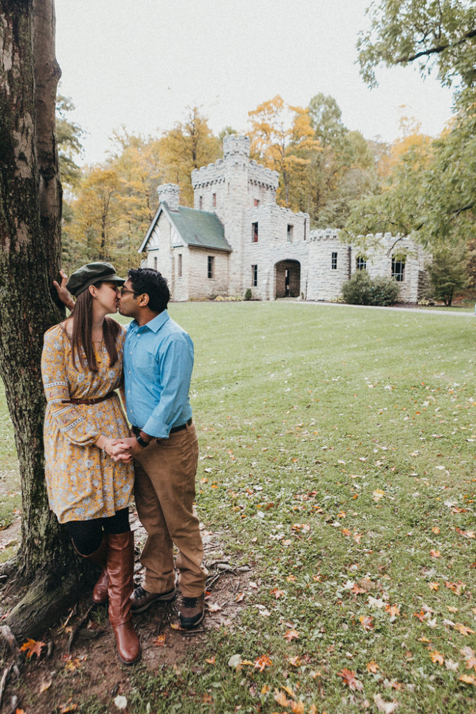 Couple Kissing in front of Castle | LMAC Photography | As seen on TodaysBride.com