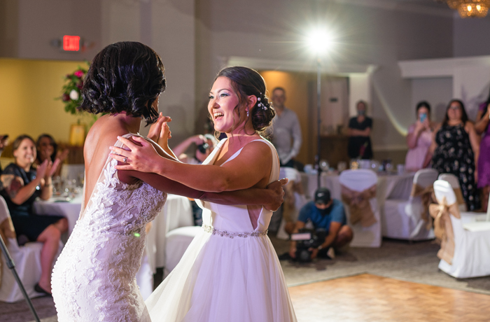 two brides dancing