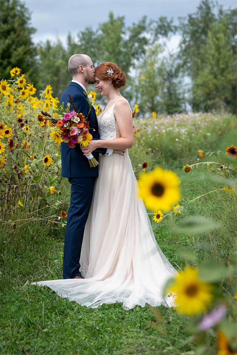 portrait of couple in sunflower field