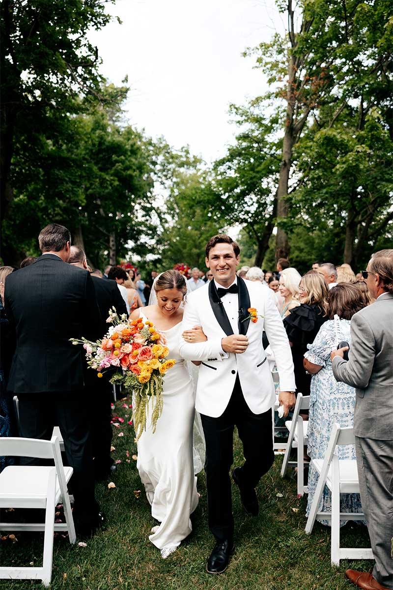 bride and groom after ceremony walk