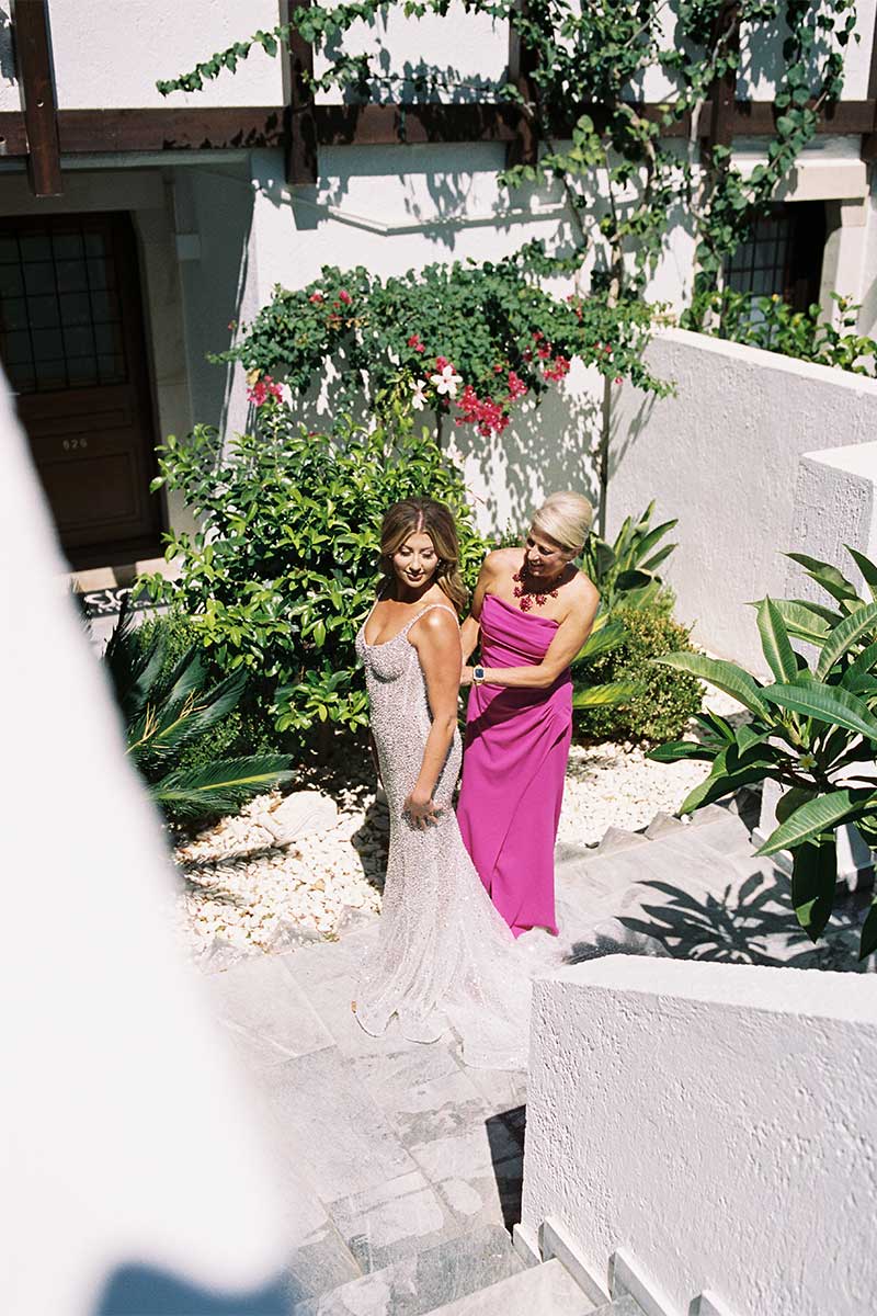 bride getting dress zipped