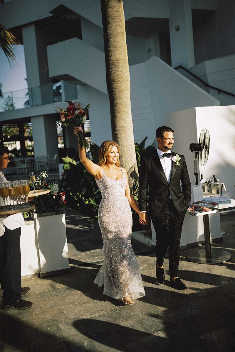 couple entering Greece wedding reception