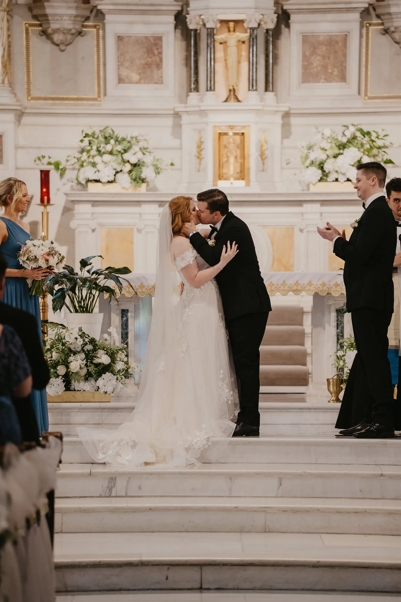 bride and groom kissing at the alter